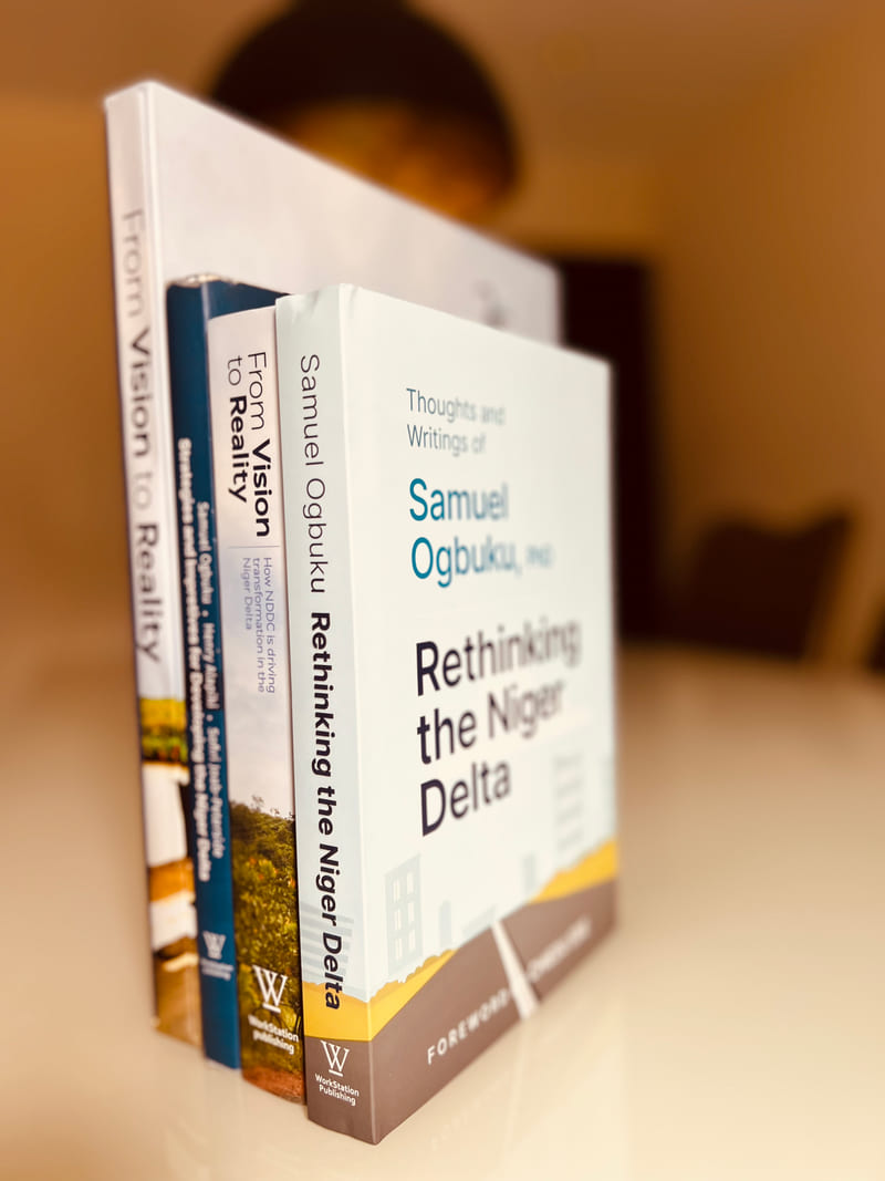 Four books from the NDDC programme stacked upright, Rethinking the Niger Delta at the front.